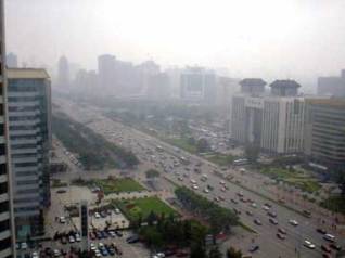 Beijing's main street gets traffic, and the smog that goes with it. © 2001, UrbisMedia