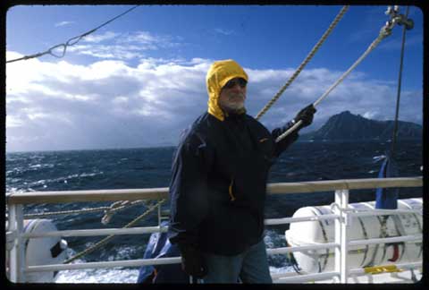 The ancient mariner briefly looks away from the horizon while rounding Cape Horn (in the distant right) Photo by S. Walls, ©UrbisMedia 1998