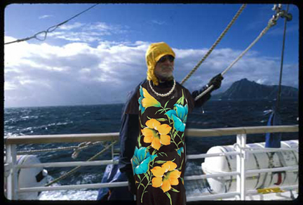 Un-retiouched photo of ancient mariner in lovely British lady flower-print dress to ward off mal de mer. The pearls were a nice nautical touch, dontcha think? Photo by S. Walls, © 1998, UrbisMedia