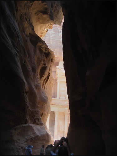 Visitors squeeze through the narrow entrance in front of the “Treasury” of Petra. © 2011, UrbisMedia