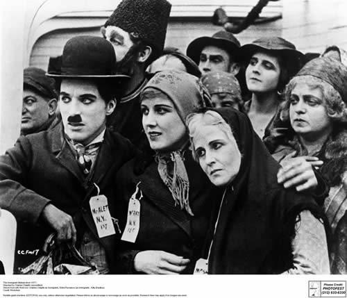 Chaplin comforts fellow nervous immigrants prior to disembarkation. The Immigrant, Mutual Pictures, 1917